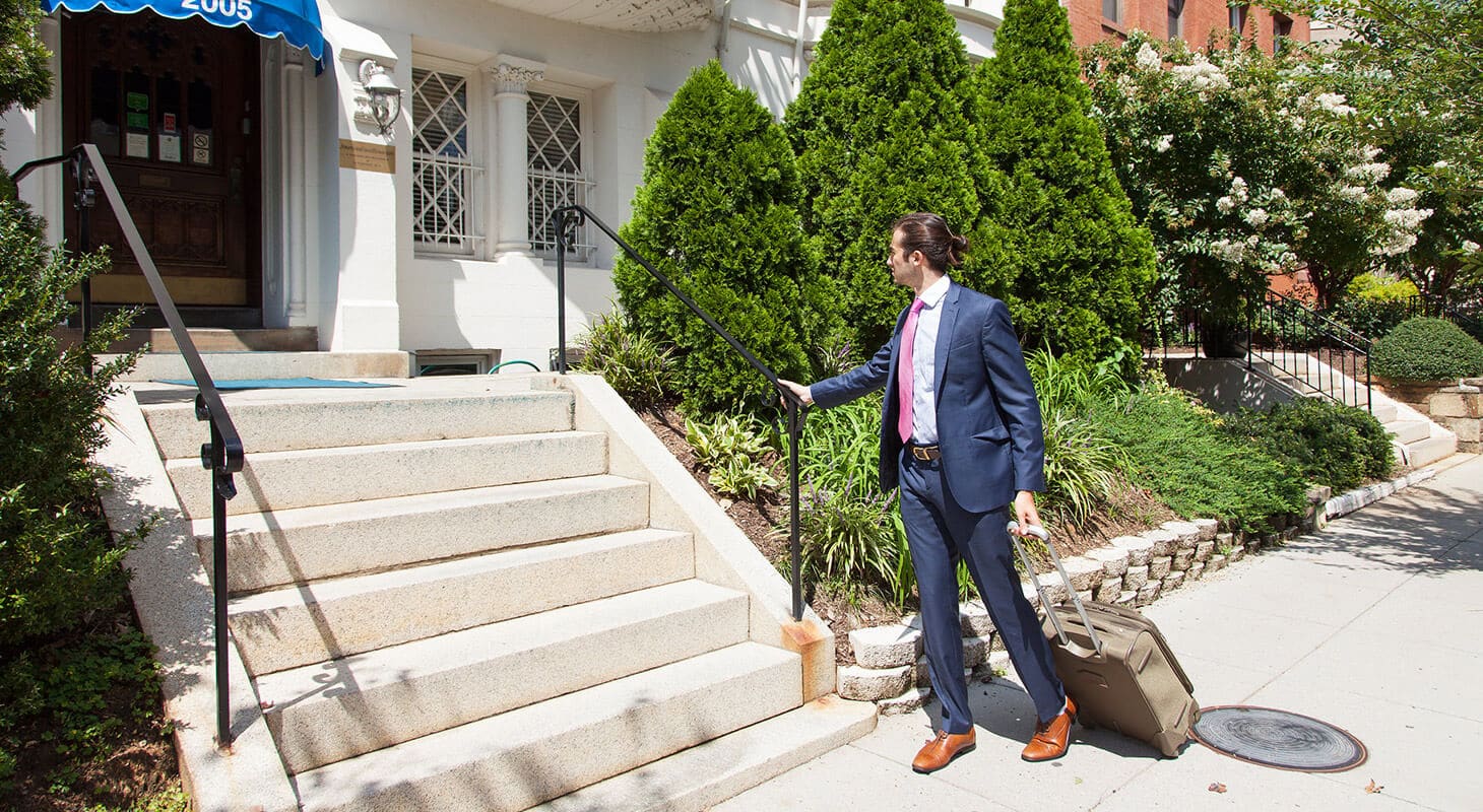 Business man walking to the front steps