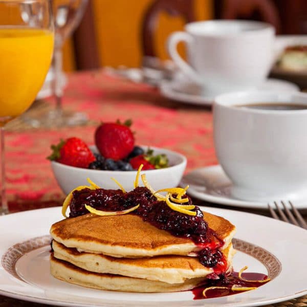 Pancakes with fruit, juice, and coffee at a Dupont Circle Inn