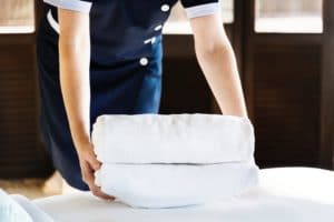 Housekeeper with folded towels