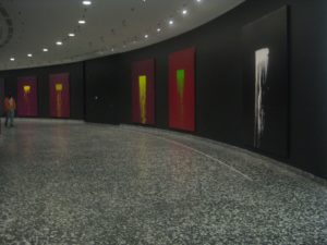 Display of paintings along a curved wall