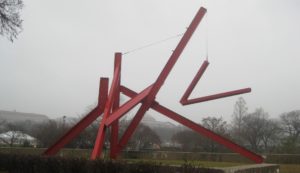 Large sculpture made of red metal bars
